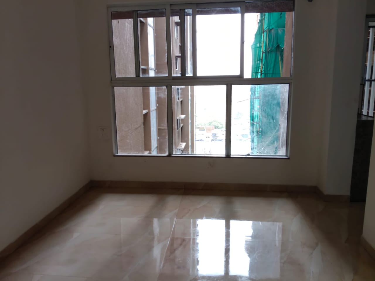Empty room with sparkling clean floor and windows after deep cleaning