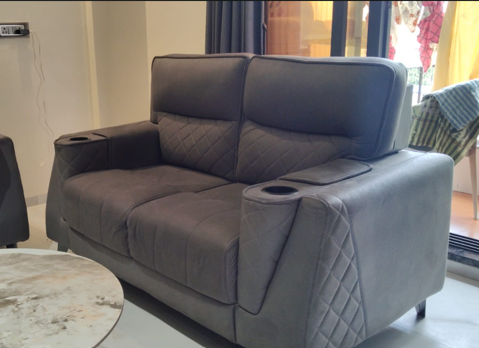 Clean grey fabric sofa in a bright living room after sofa cleaning