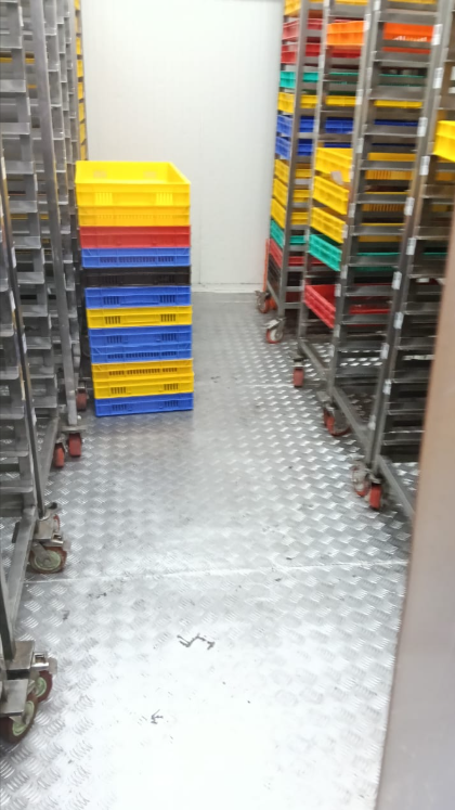 Clean and organised storage area with stacked crates after cleaning