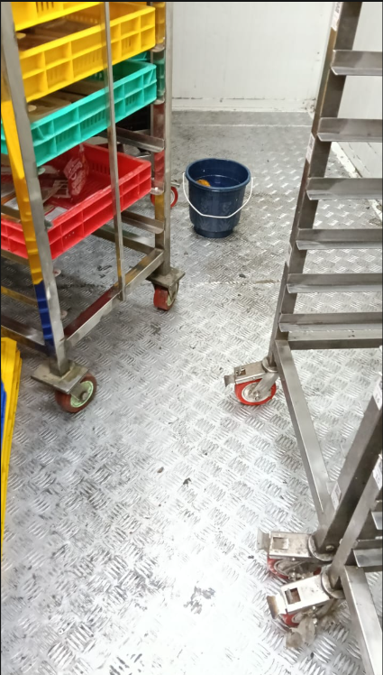 Before: dirty commercial storage floor with scattered crates